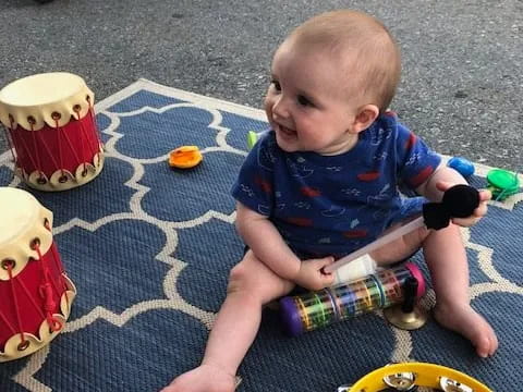 a baby sitting on the ground