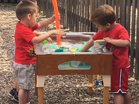 two boys playing with a table