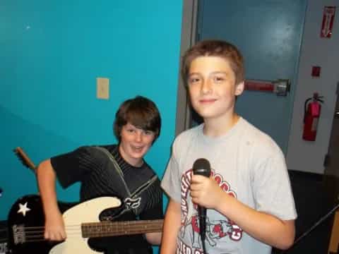 a couple of boys holding guitars