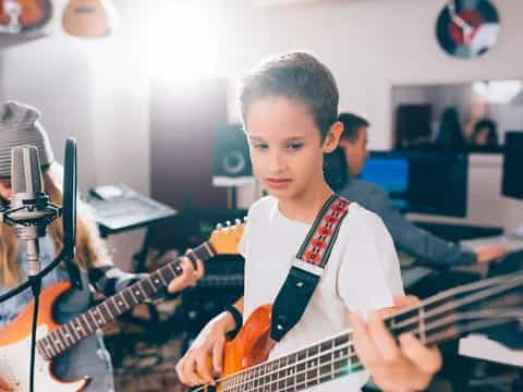 a boy playing a guitar