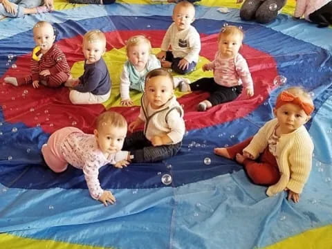 a group of children sitting on a rug