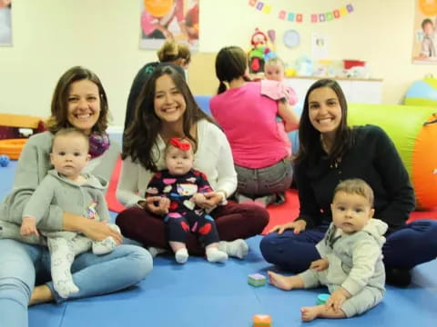 a group of people sitting on the floor posing for the camera