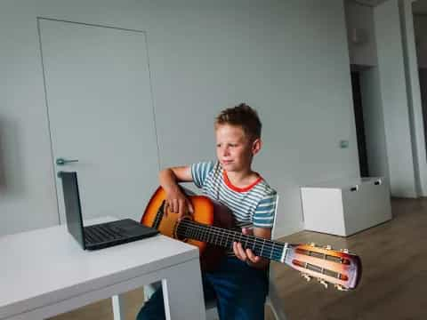 a boy playing a guitar