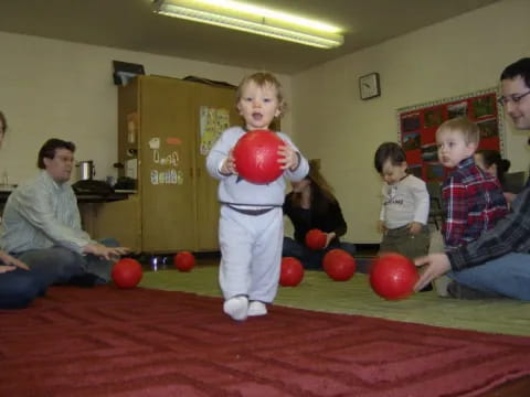 a group of kids playing with balls