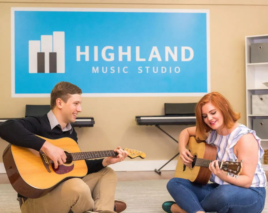 a man and a woman playing guitar