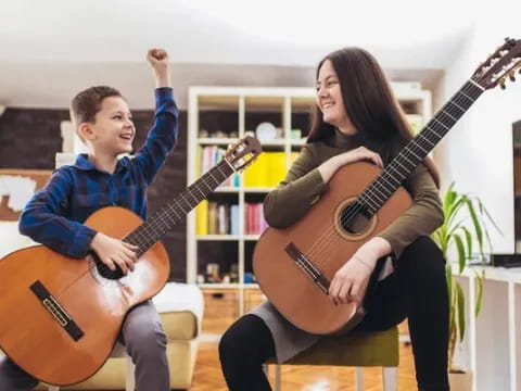 a man and woman playing guitars