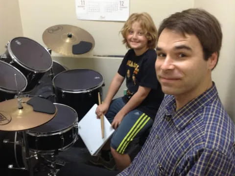 a person and a child playing drums