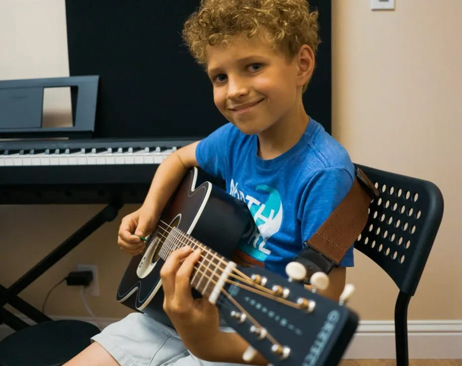 a boy playing a guitar