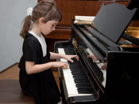 a girl playing a piano