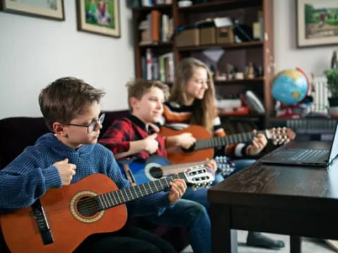 a group of kids playing guitars