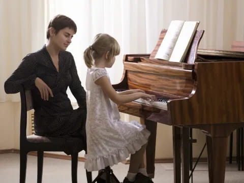 a woman playing a piano