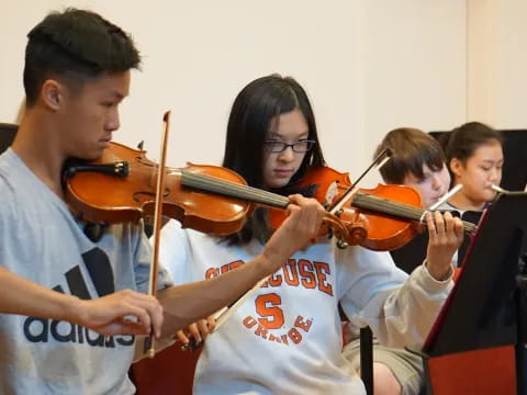 a group of people playing violin