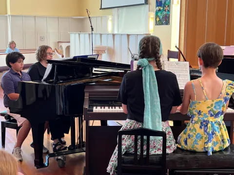 a group of people playing piano