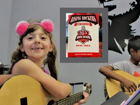 a girl playing a guitar next to a boy playing a guitar