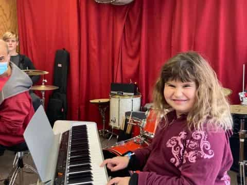 a girl playing a piano