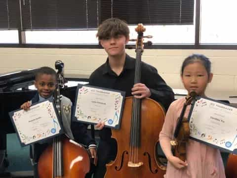 a group of kids playing musical instruments