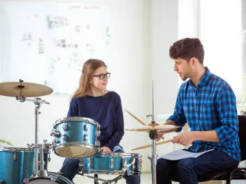 a man and a woman playing drums