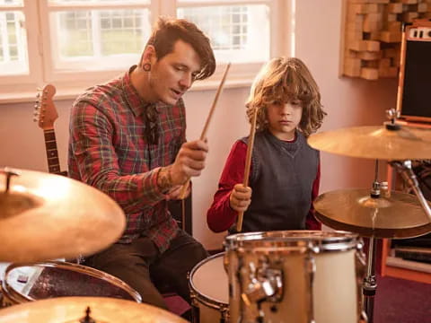 a person and a girl playing drums