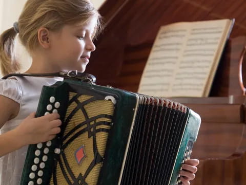 a girl playing a piano