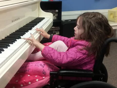 a girl playing a piano