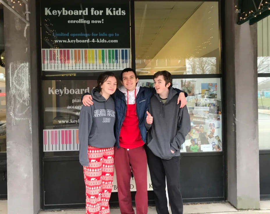 a group of people posing for a photo in front of a store