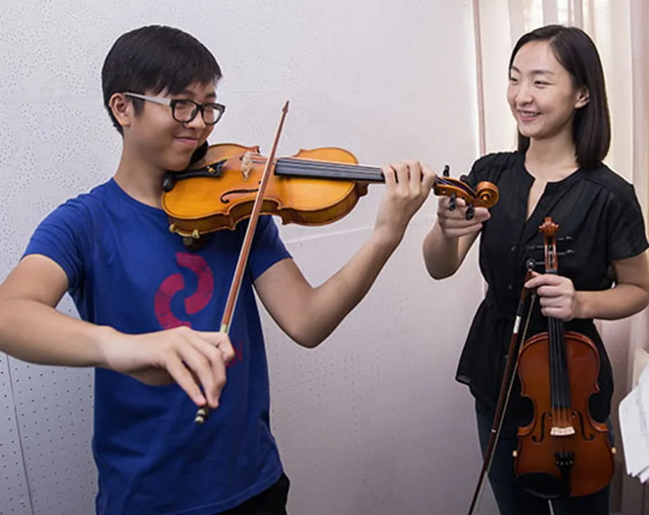 a man and a woman playing violin