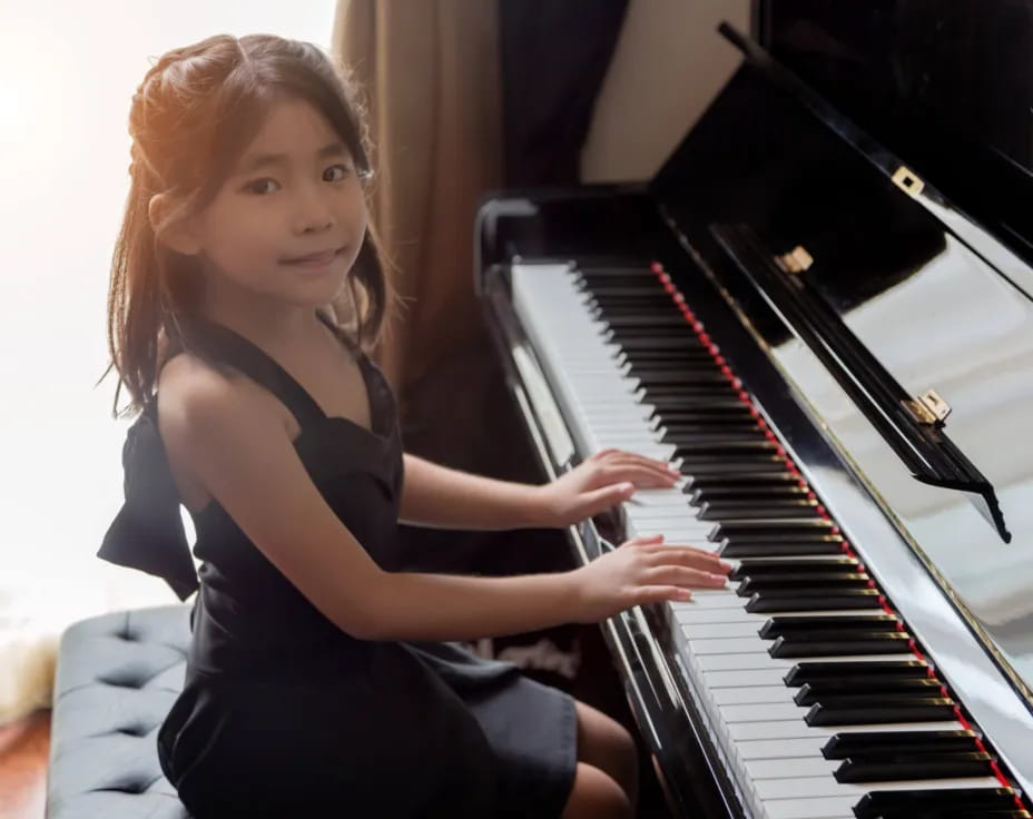 a girl playing a piano