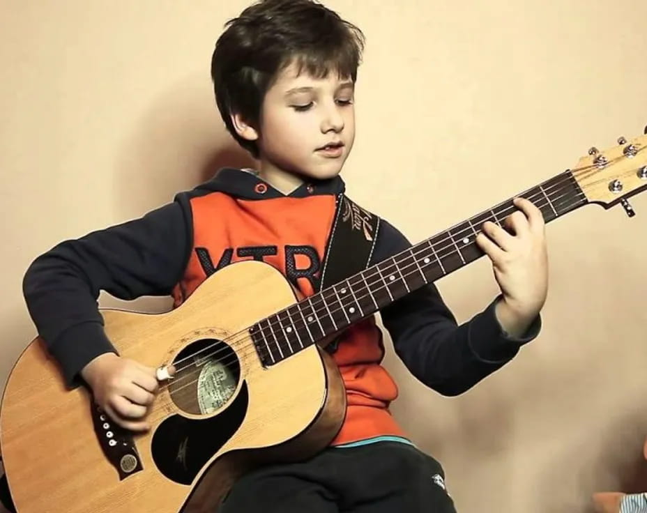 a boy playing a guitar