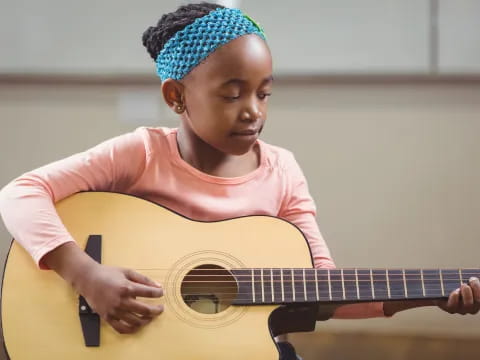 a girl playing a guitar