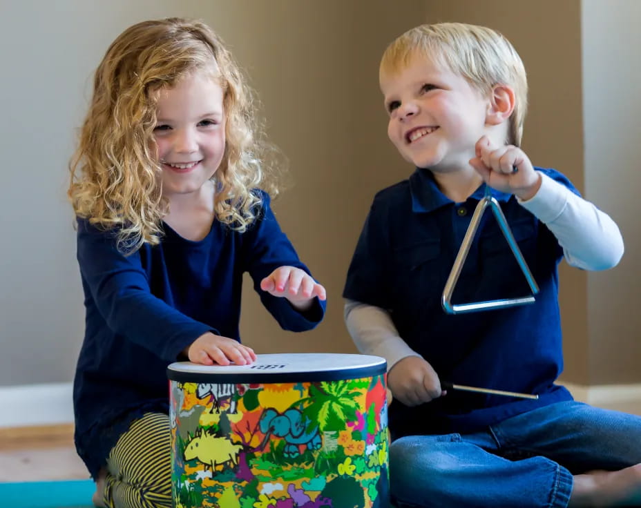 a boy and girl holding a gift box