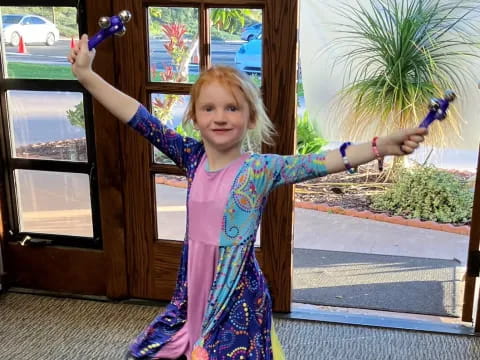 a girl holding a toy sword