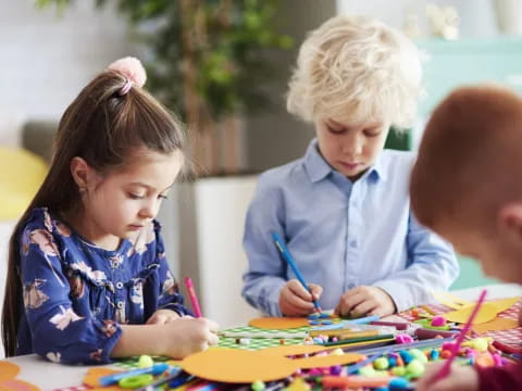 a group of children sitting at a table