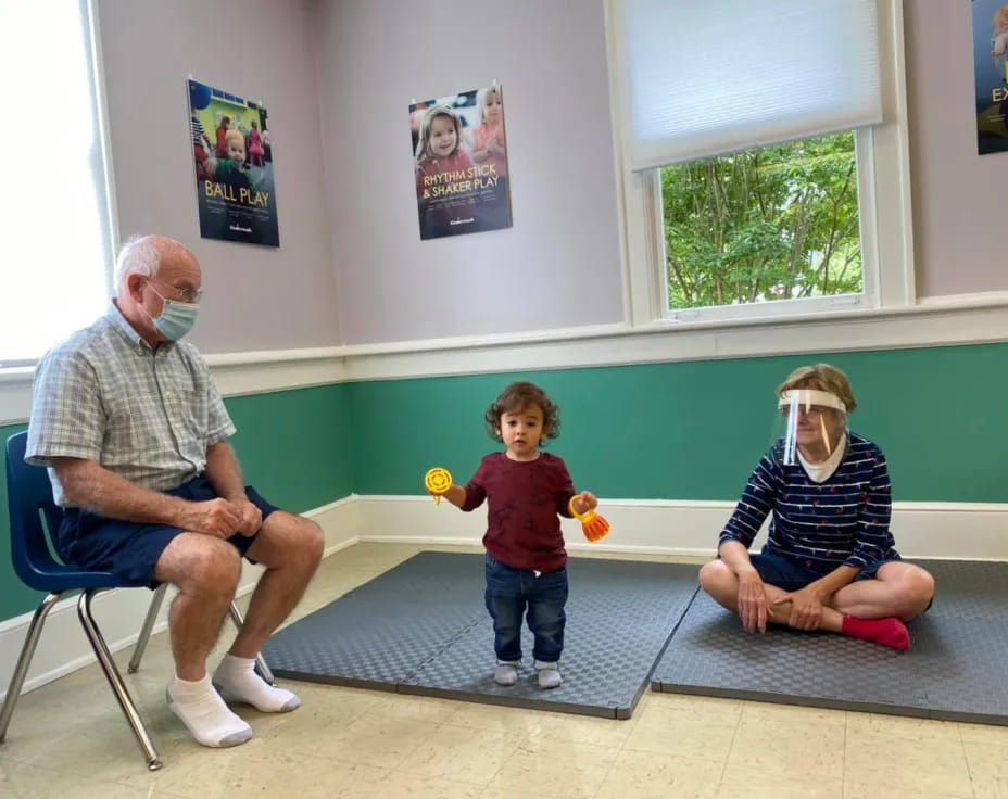 a person and a child sitting on a bench in a room