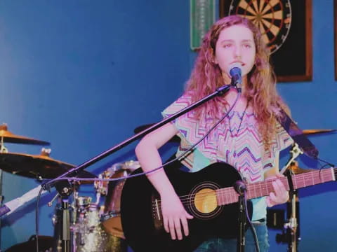 a woman playing a guitar