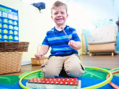 a boy sitting on a mat