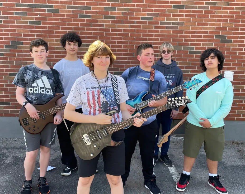 a group of people holding instruments