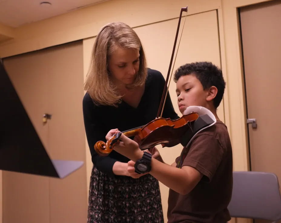 a boy and girl playing violin