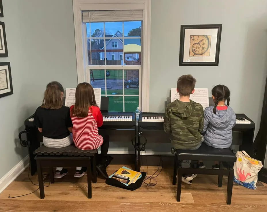 a group of children playing piano