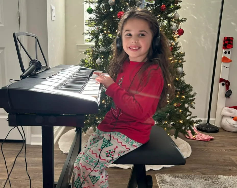 a girl sitting at a piano