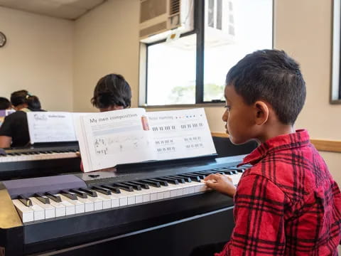 a boy playing a piano