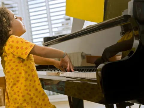 a woman playing a piano