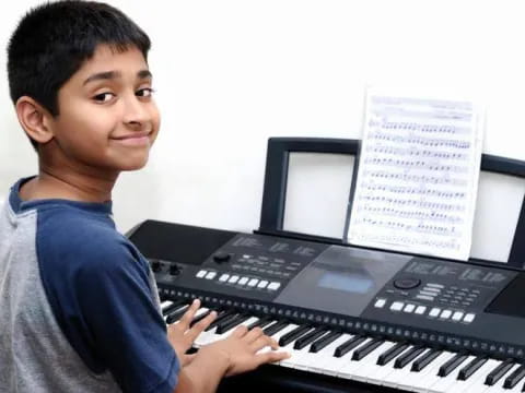 a boy playing a piano