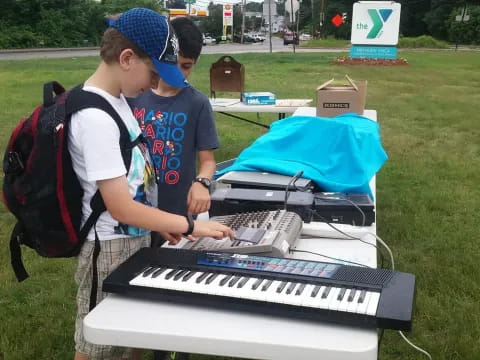 a couple of boys playing a piano