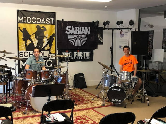 a couple of men playing drums