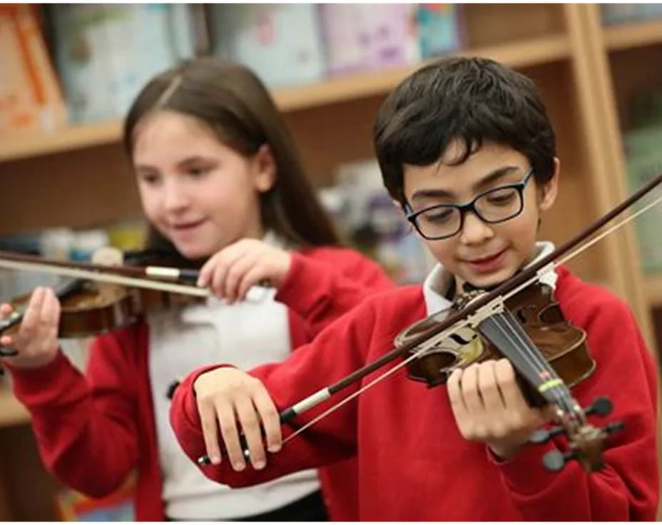 a boy and girl playing violin