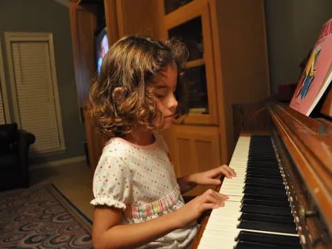 a girl playing a piano