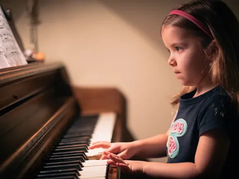 a girl playing a piano