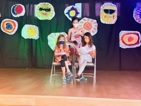 a group of women sitting on chairs