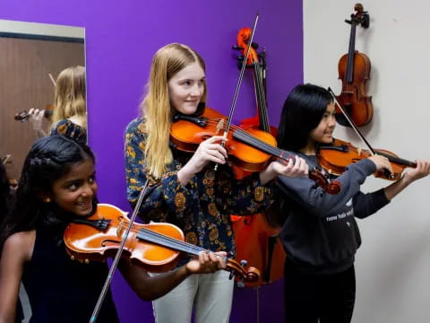 a group of women playing violin