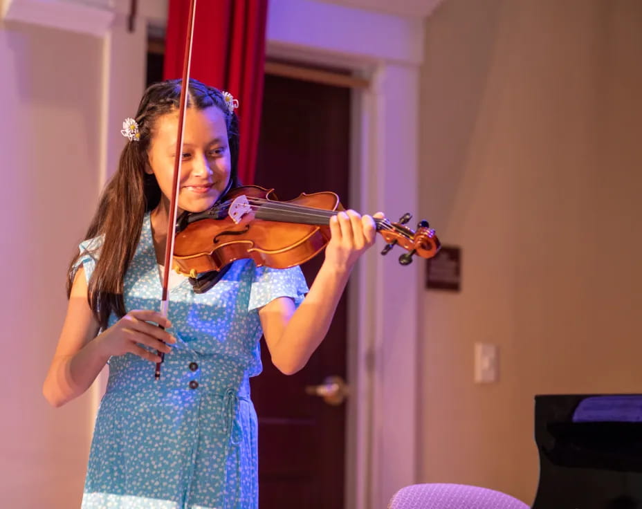 a girl playing a violin